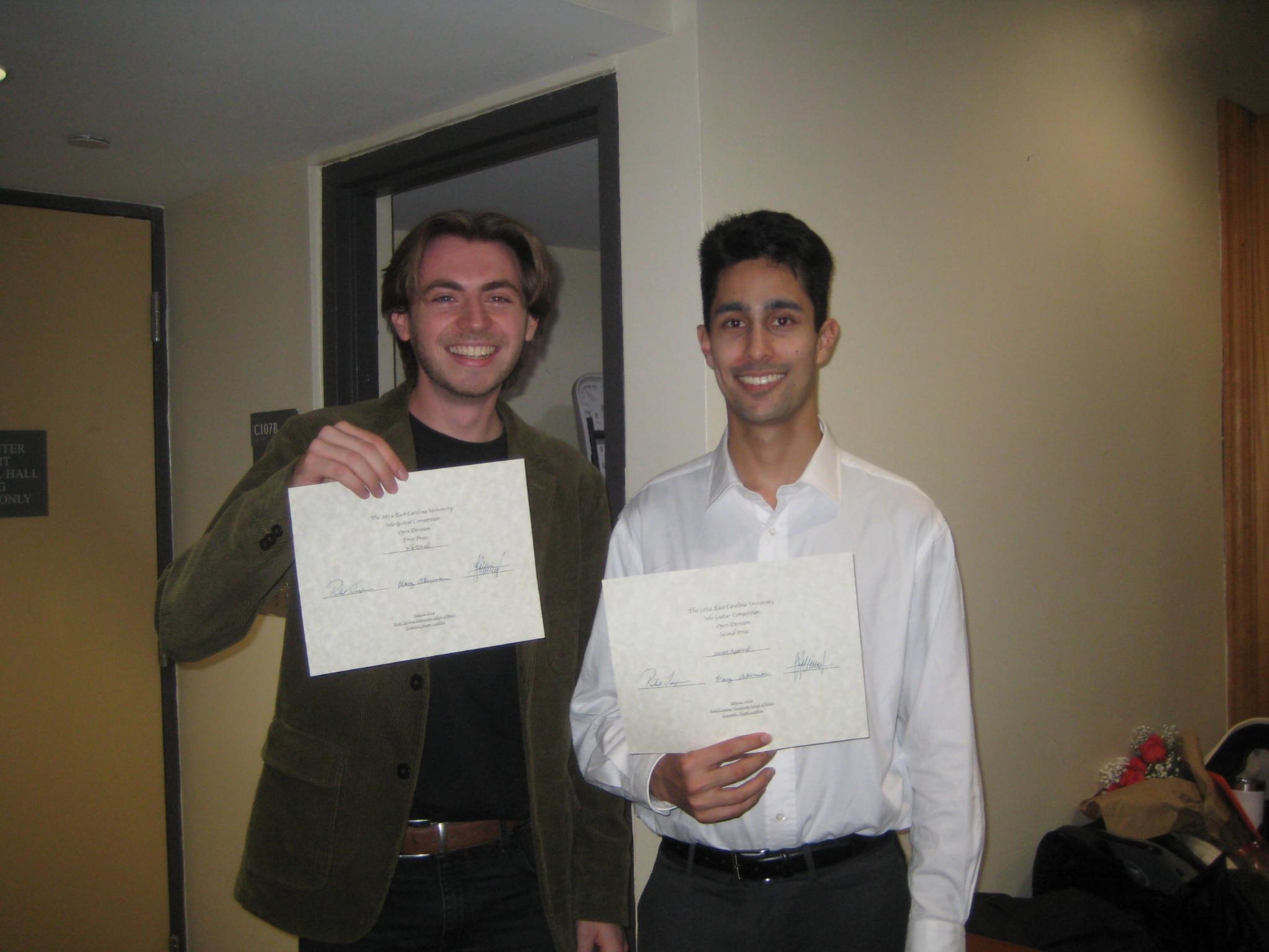 Suvan Agarwal and Nik Divall holding awards from ECU